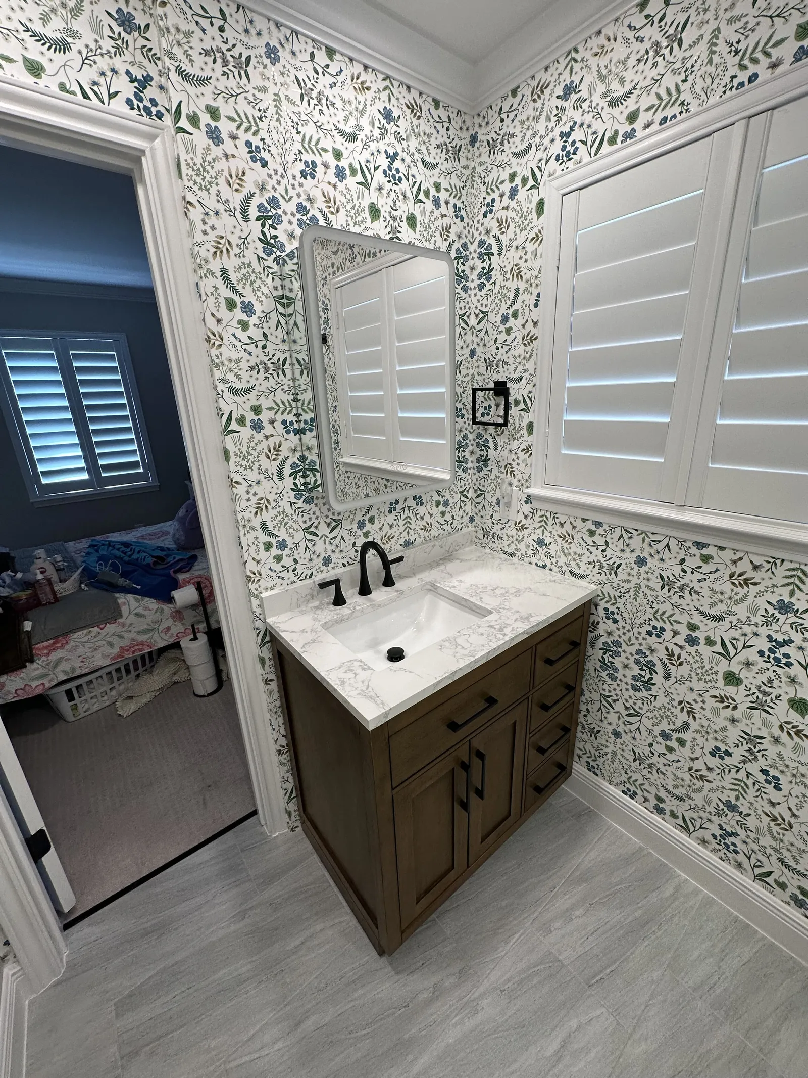 New vanity and wallpaper in a finished bathroom
