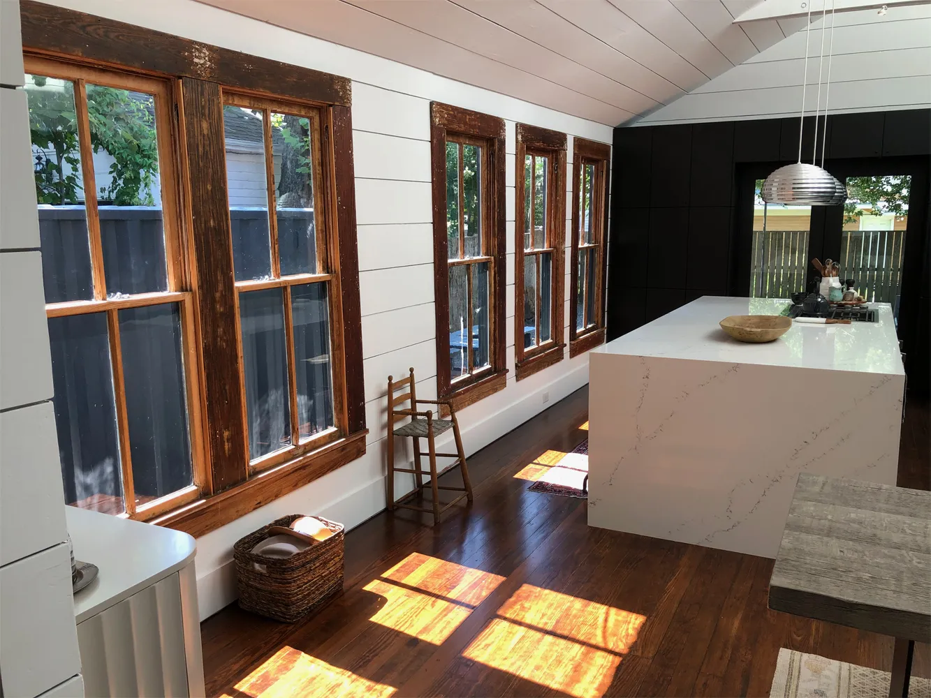 Kitchen remodel with restored original wood windows in a historic Houston bungalow